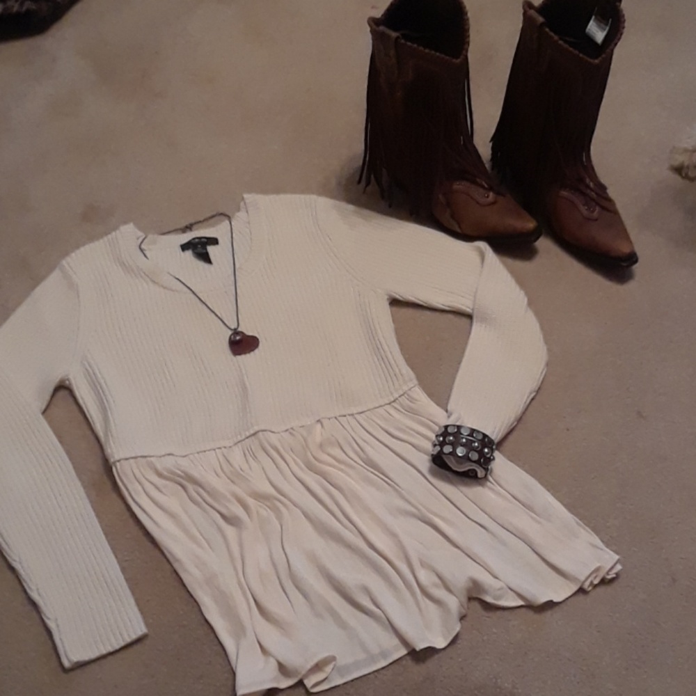 Off white sweater with semi sheer bottom.